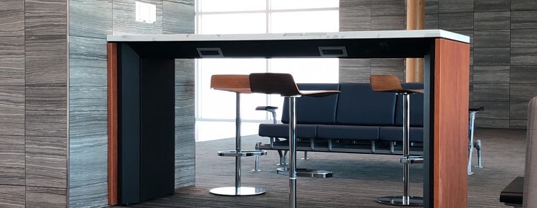 airport charging table with solid surface top and wood side panels at Airport Terminal