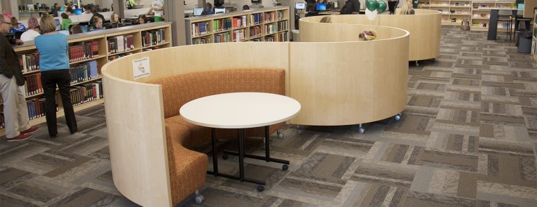 Curved banquette seating with wood privacy panels in serpentine design for collaboration at public library