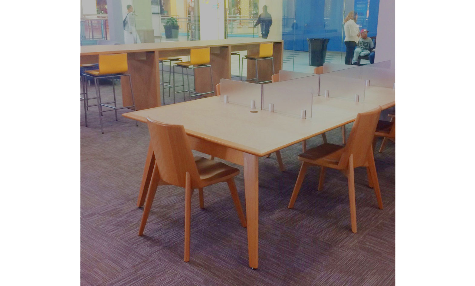 Public Library furniture showing wood tables with wood pull up chairs and frosted acrylic divider panels