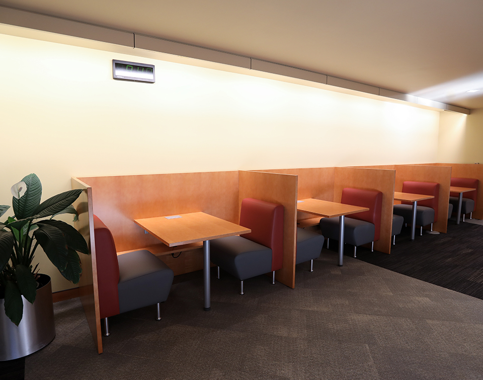 Two person modern study carrel with integrated seating and access to power in public library