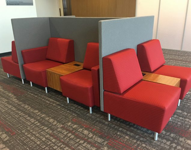 Modular lounge seating with privacy panels and powered tables in University Library