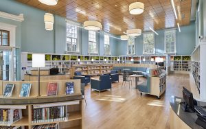 curved library shelving with book display on casters and seating