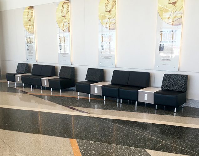 Airport seating with power outlets, stone top tables