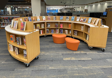 circular library shelving unit on casters with book display