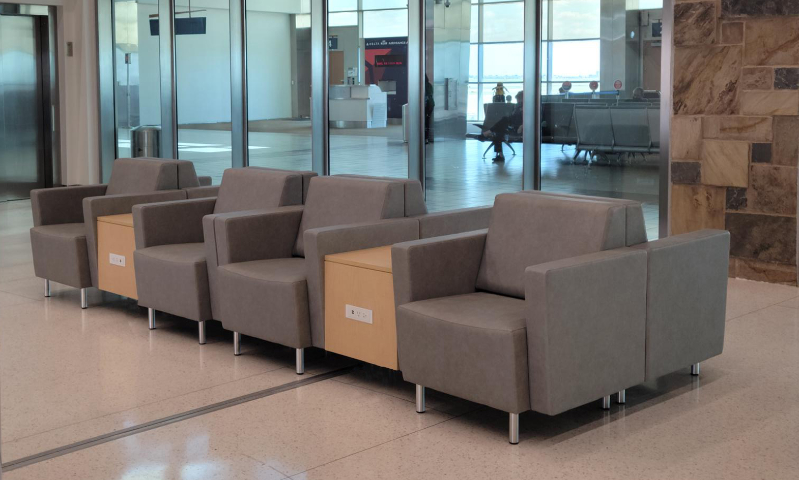 Lounge chairs with powered tables in Airport Terminal