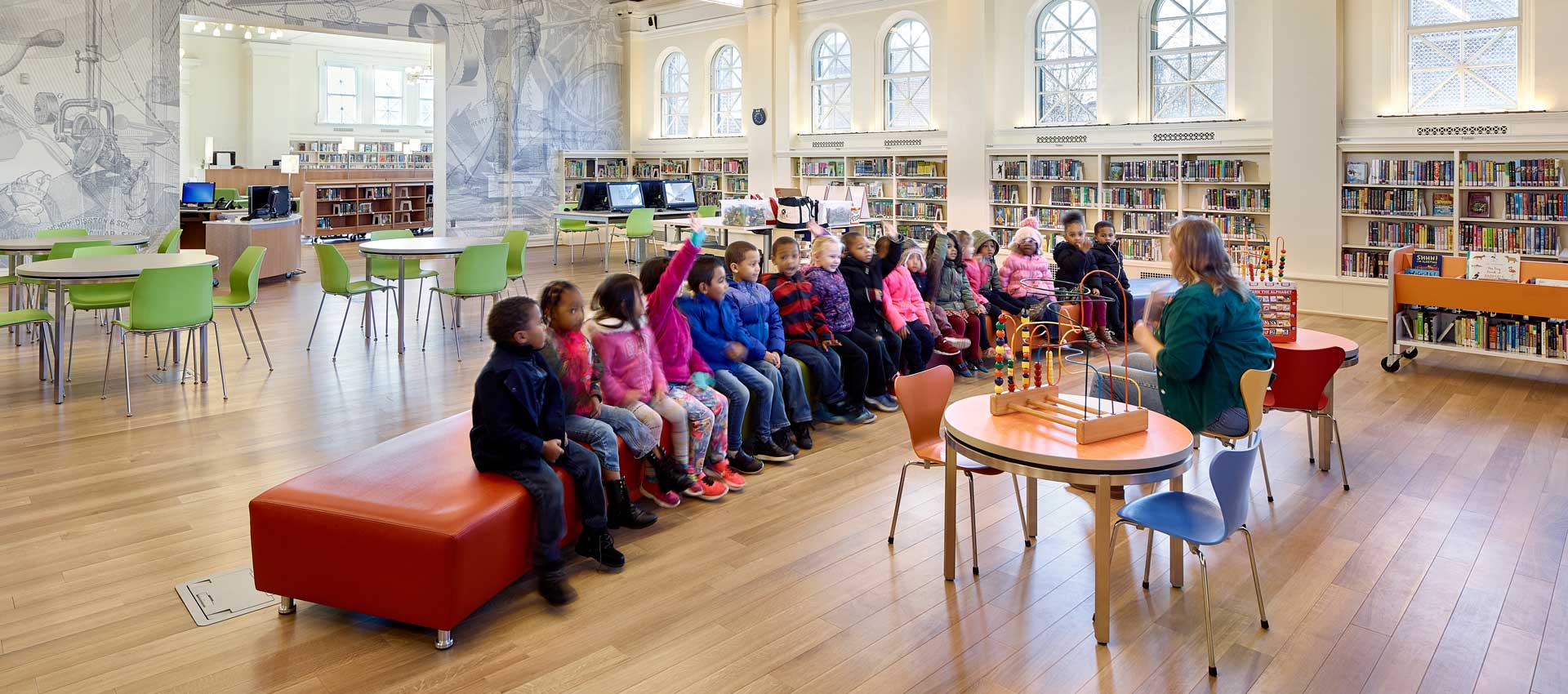 Children listening on bench in Public Library