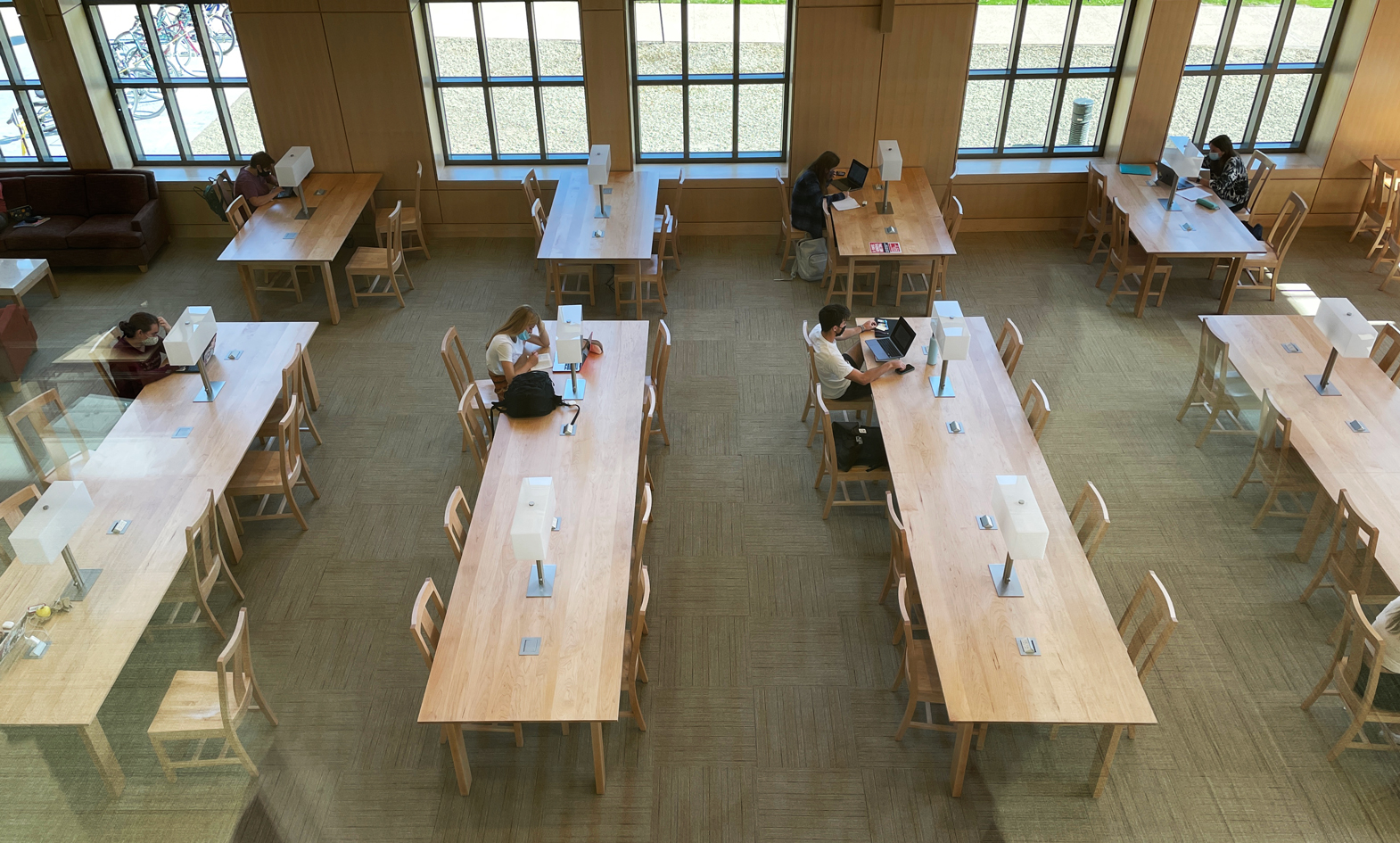 overhead view of Kenyon College custom wood library tables with integrated lamp and matching wood pull up chairs