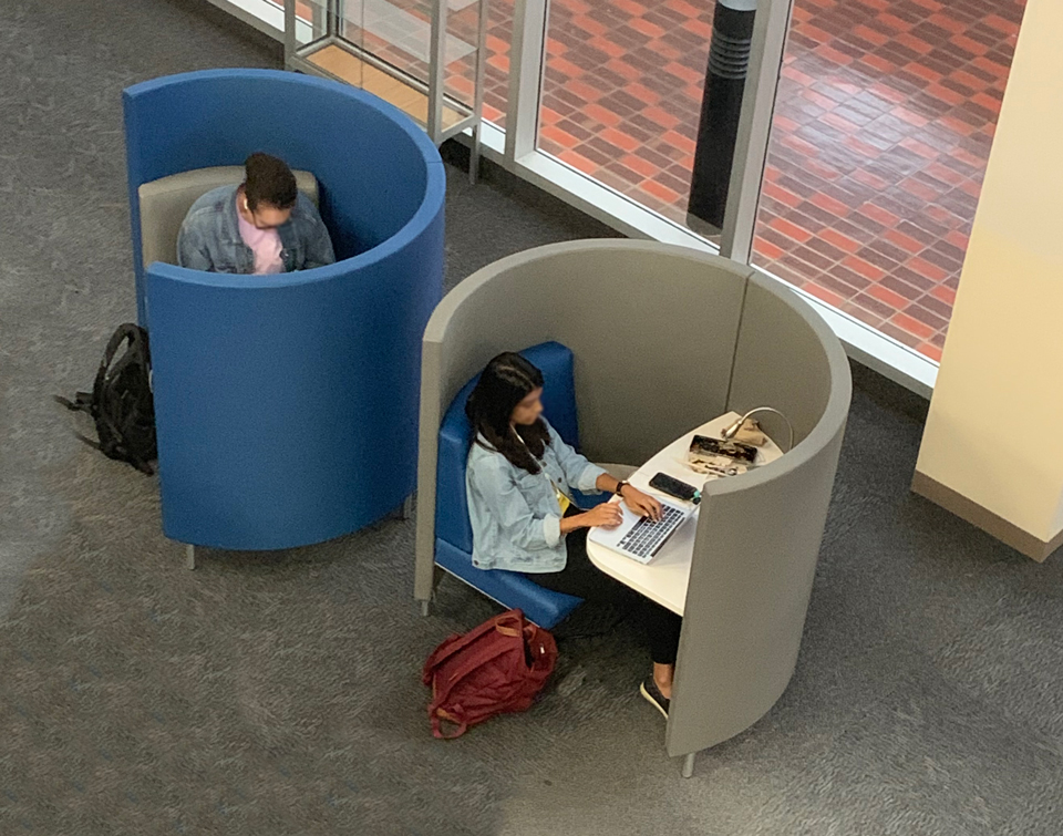 college students studying in modern study carrel POD in university library