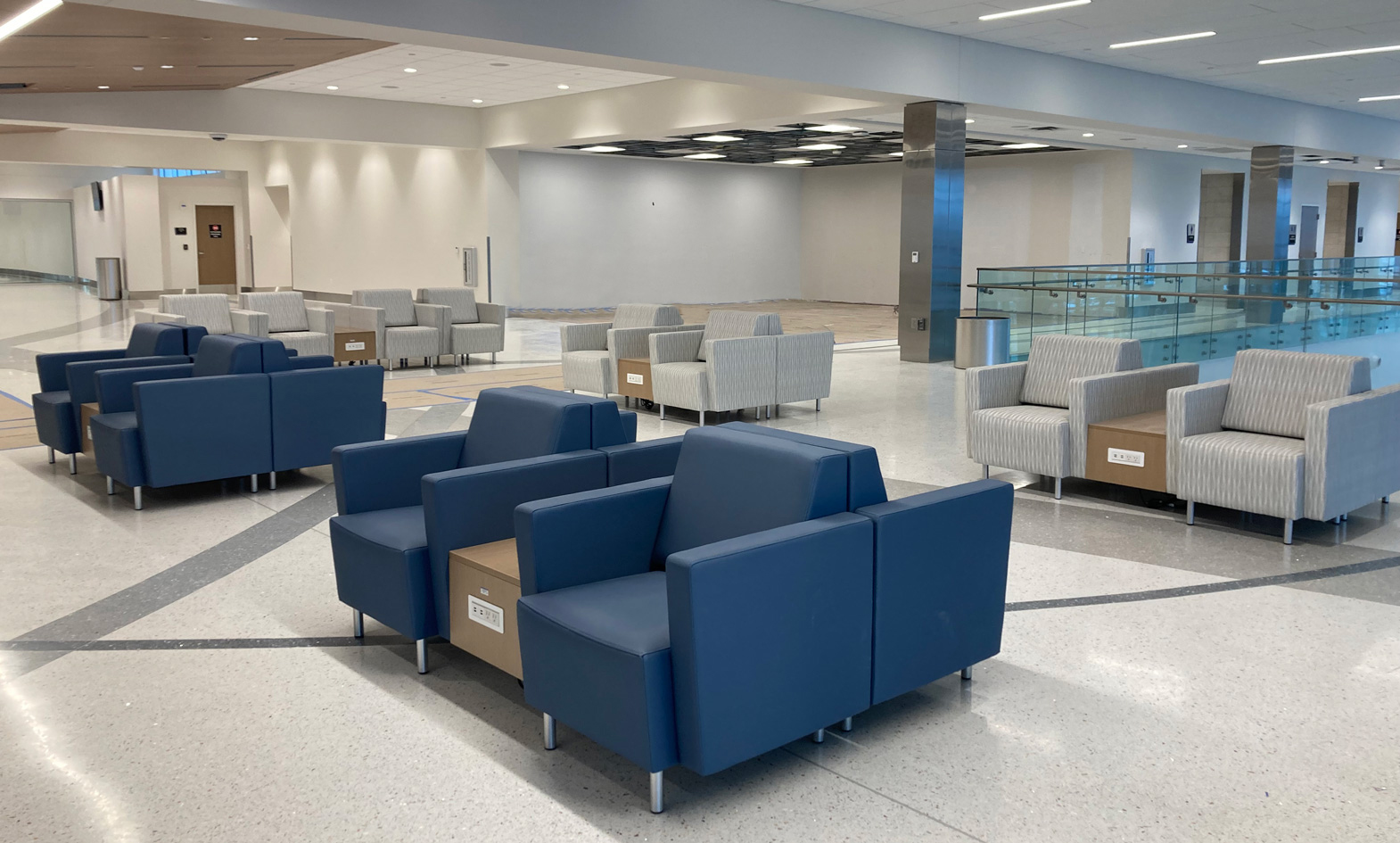 Airport seating lounge chairs with power charging tables in terminal