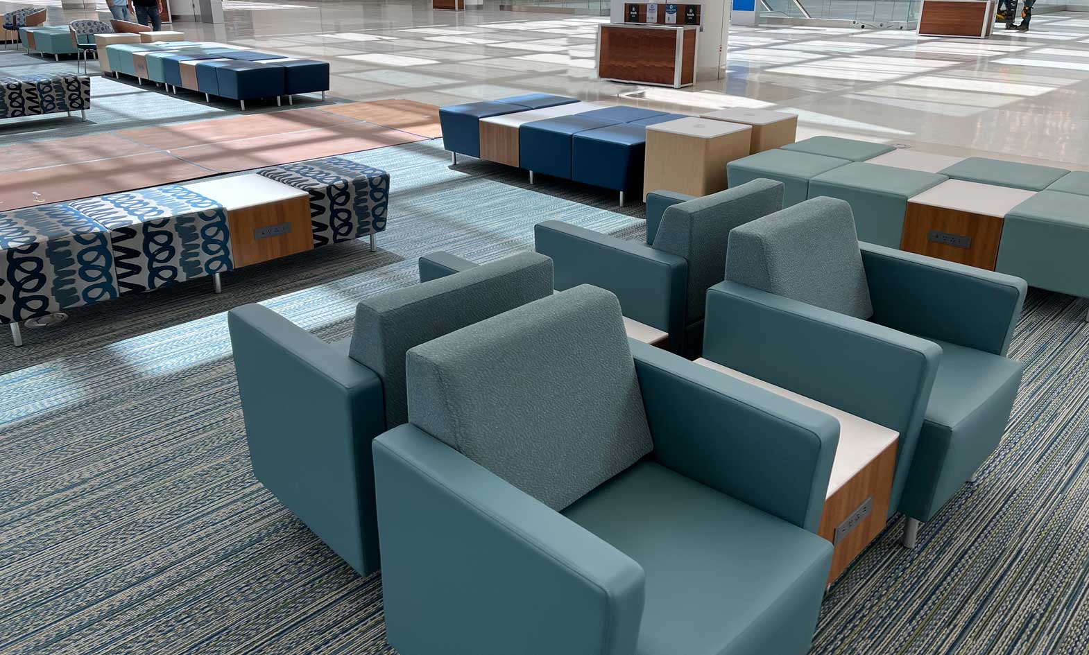 Airport seating with lounge chairs, benches and powered occasional tables