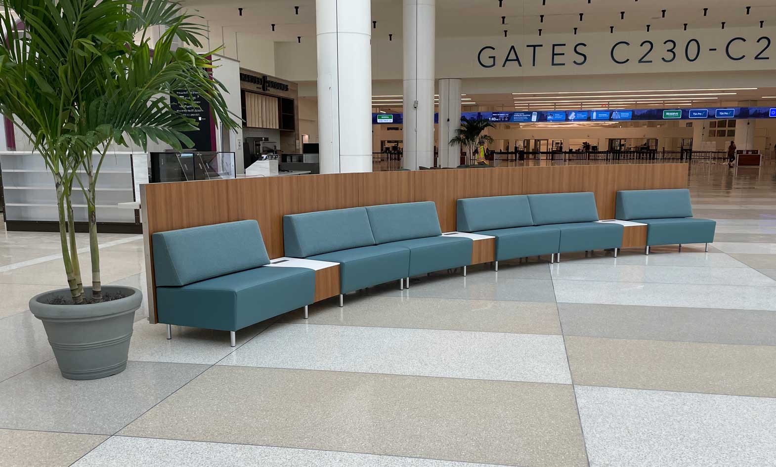 Curved Airport Seating with privacy panel and powered occasional tables