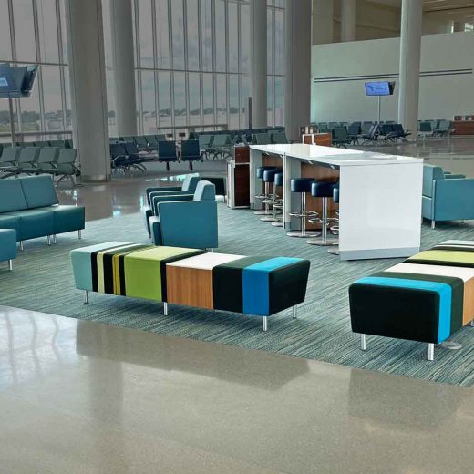 Airport seating with lounge chairs, benches and powered occasional table and charging table