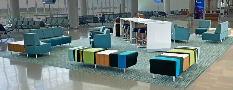 Airport seating with lounge chairs, benches and powered occasional table and charging table