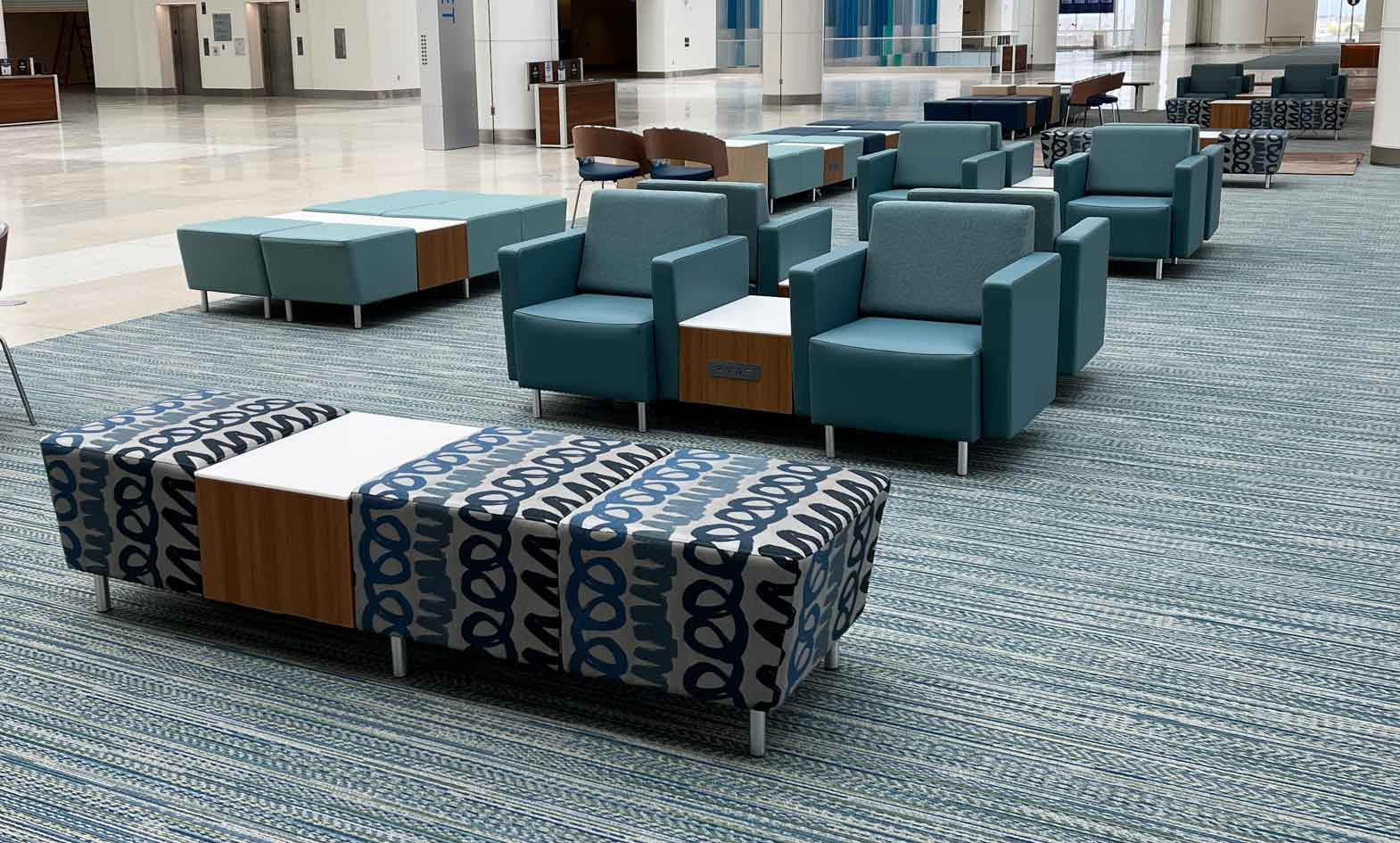 Airport seating with lounge chairs, benches and powered occasional tables