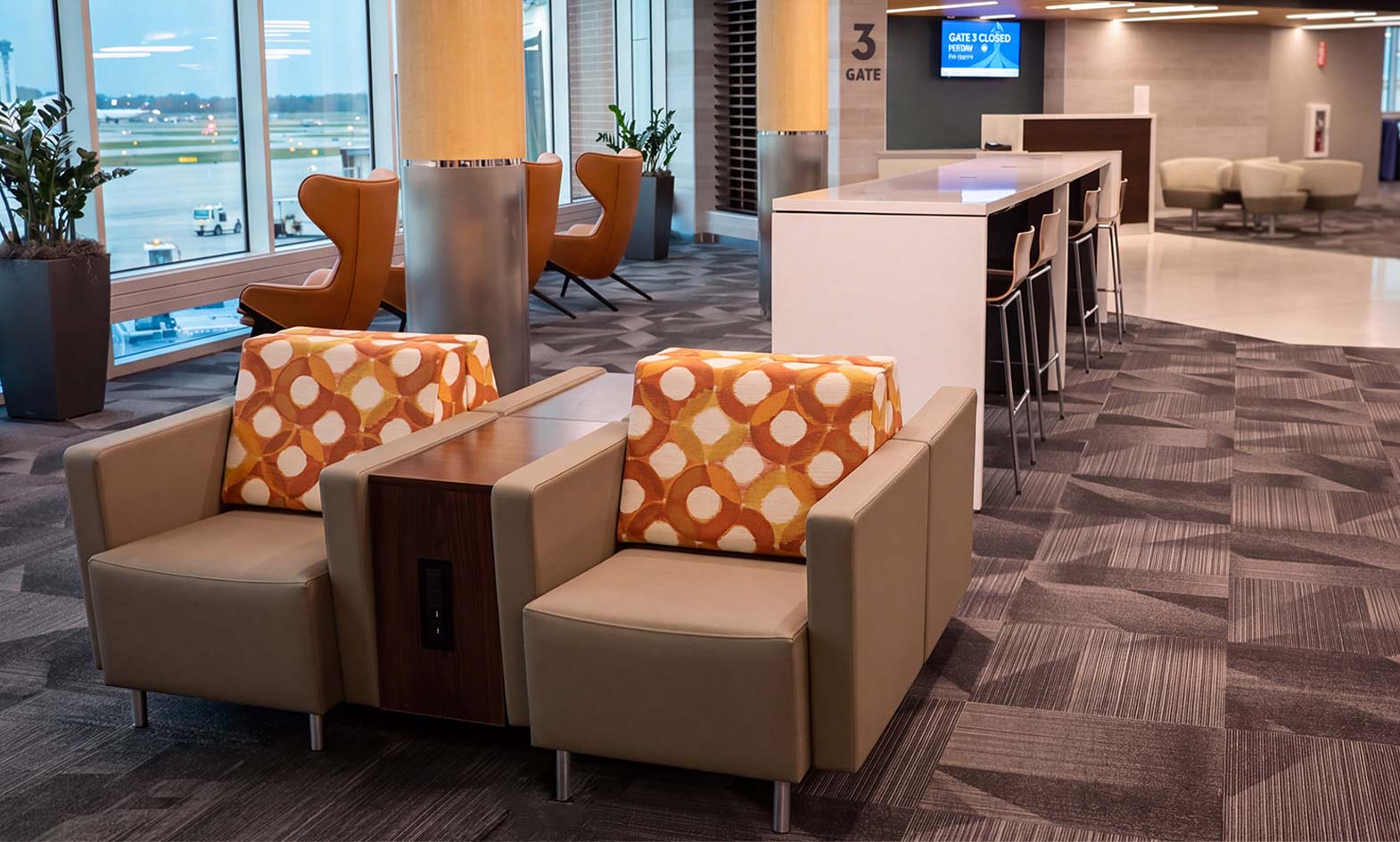 Lounge chairs, powerbar and bar-height chairs by agati furniture at gate in fort wayne airport