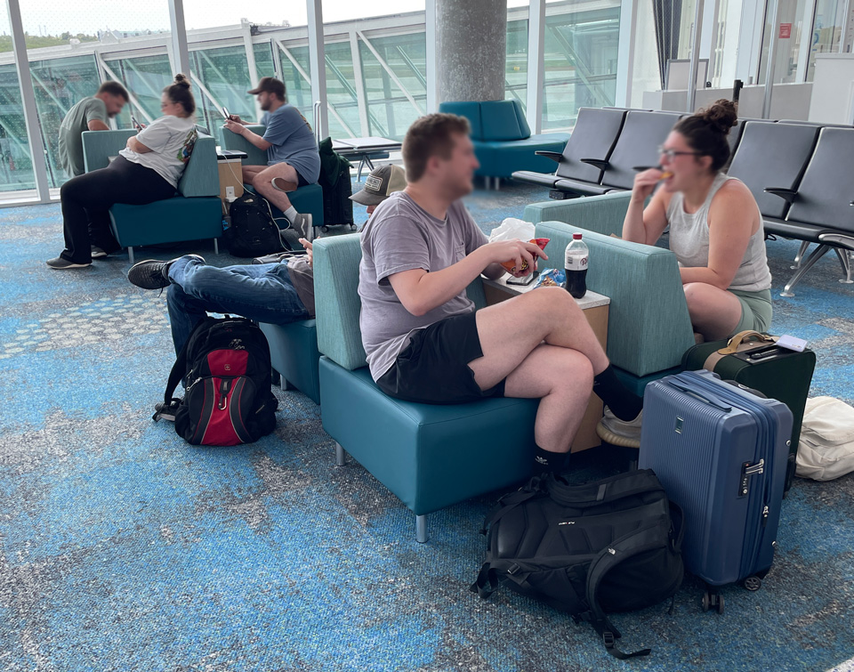 Group Gee Pinwheel lounge seating full of happy travelers at Key West Airport