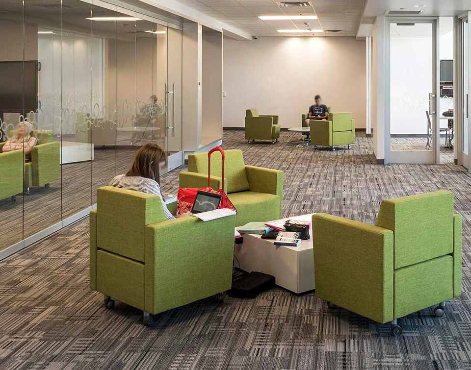 Community College students resting in lounge chairs