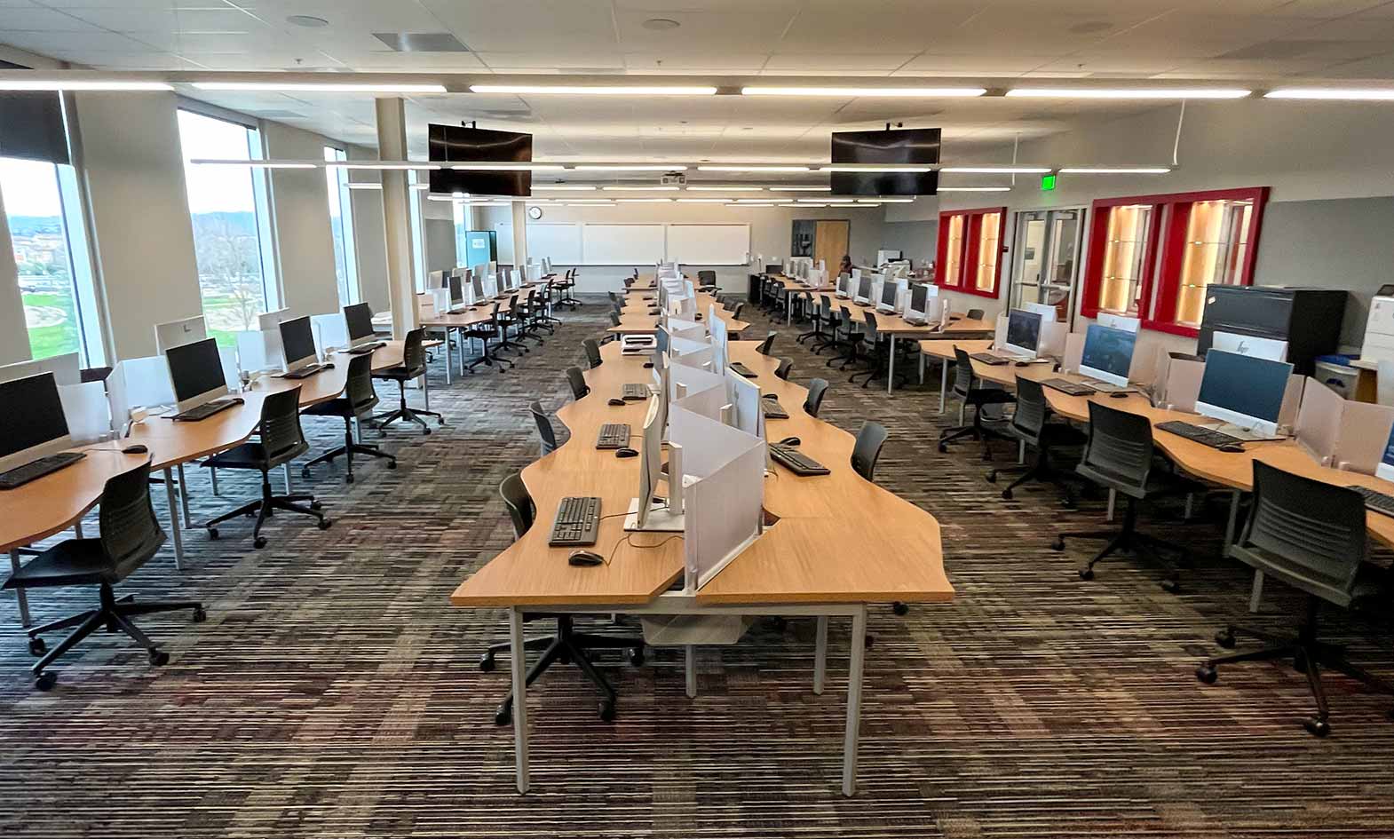 rows of tables in a computer lab at las positas college featuring agati adapt computer workstations