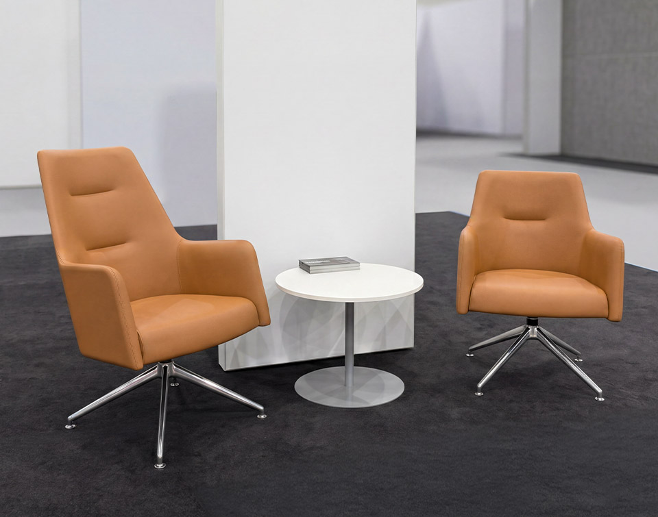 The Etta High back lounge chair and the guest chair side by side at AAAE.