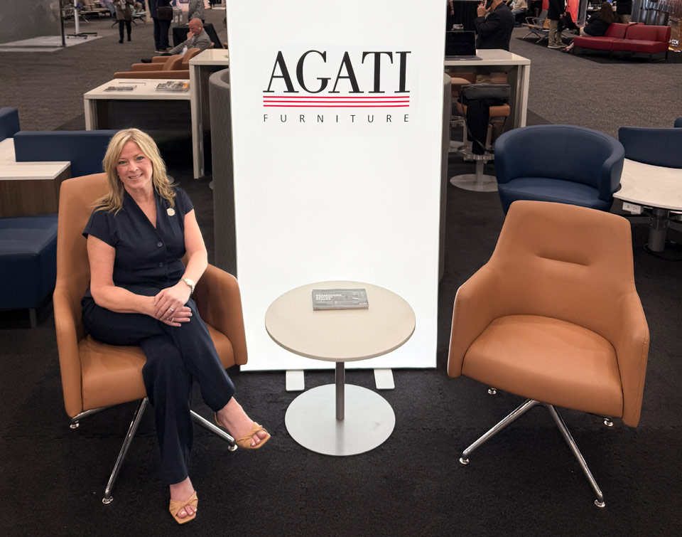 Agati's VP of Sales, Beret Ek sitting in the Etta High Back Lounge Chair at the AAAE Conference in 2026
