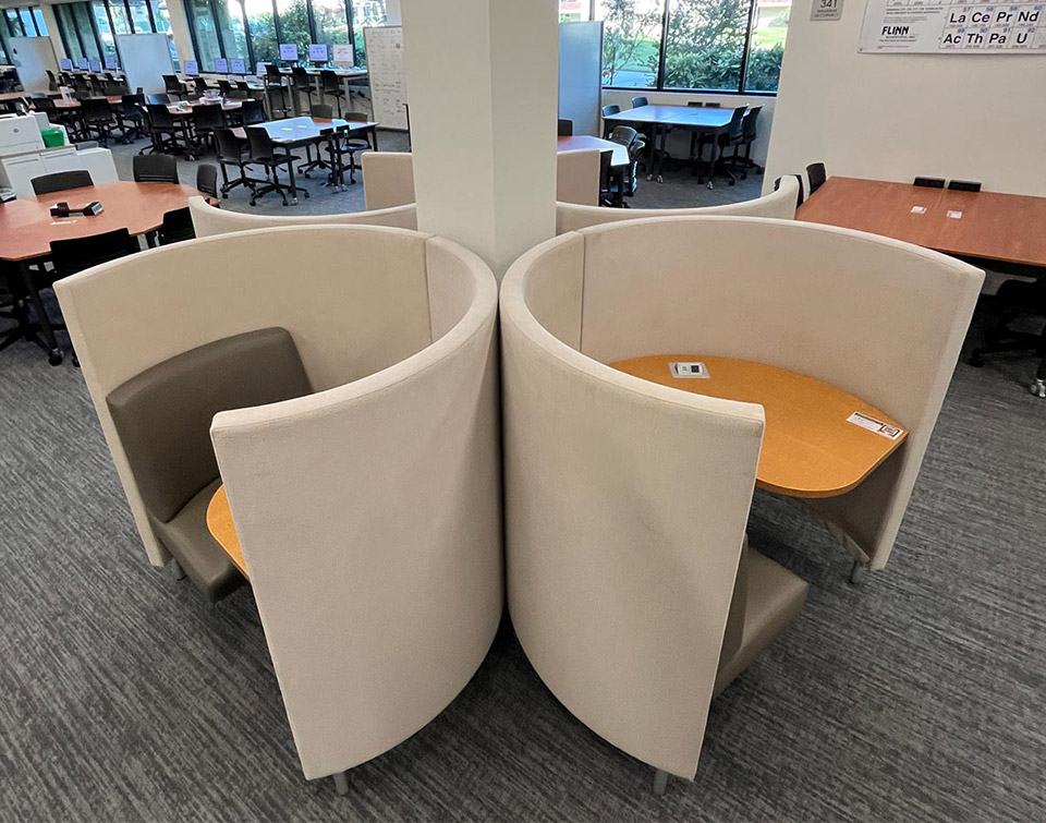 Agati study pods arranged in a clover formation around a pillar, making efficient use of library floor space