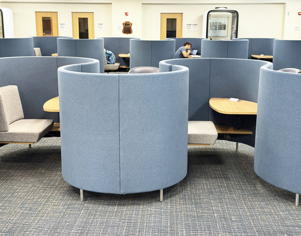 Blue curved AGATI Single POD study carrels with individual seats and tables at UVA’s Claude Moore Library.