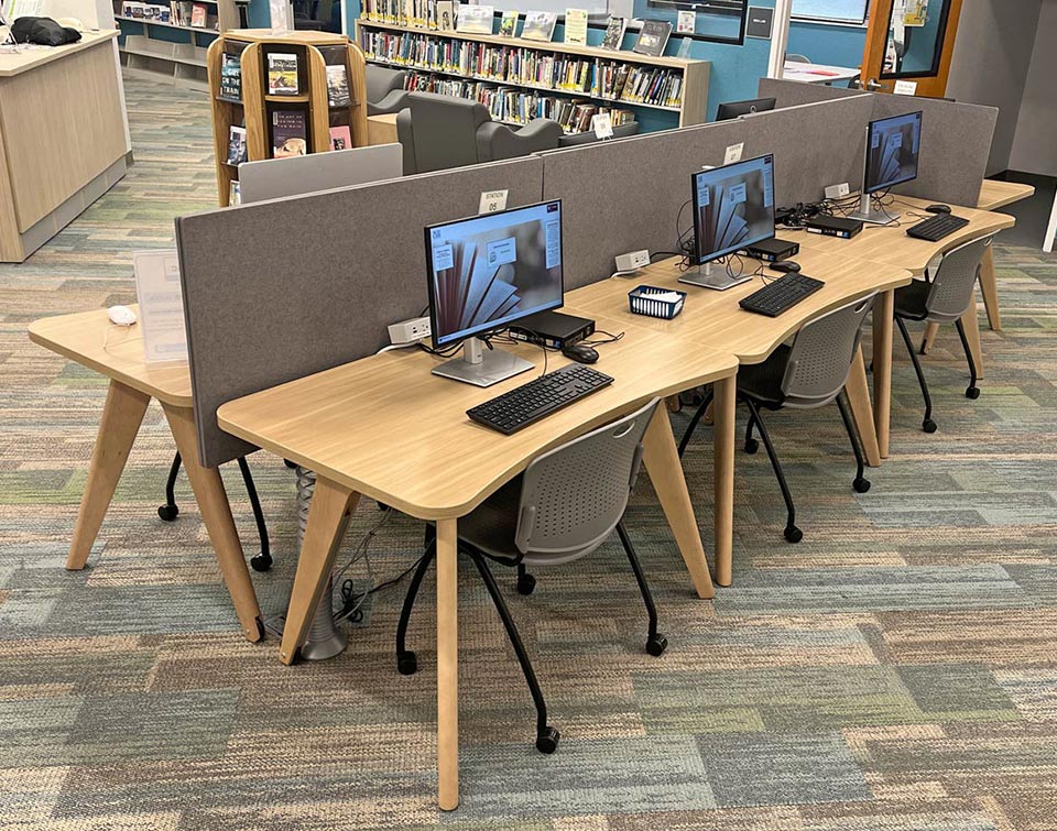 Adapt2 tables functioning as computer workstations in a library space