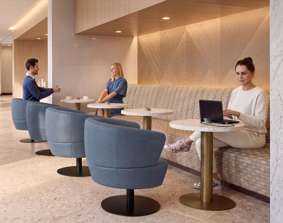 People in an airport lounge seated at some metal based tables